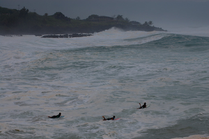 Paddling out through the maelstrom of Waimea Bay on a large day.